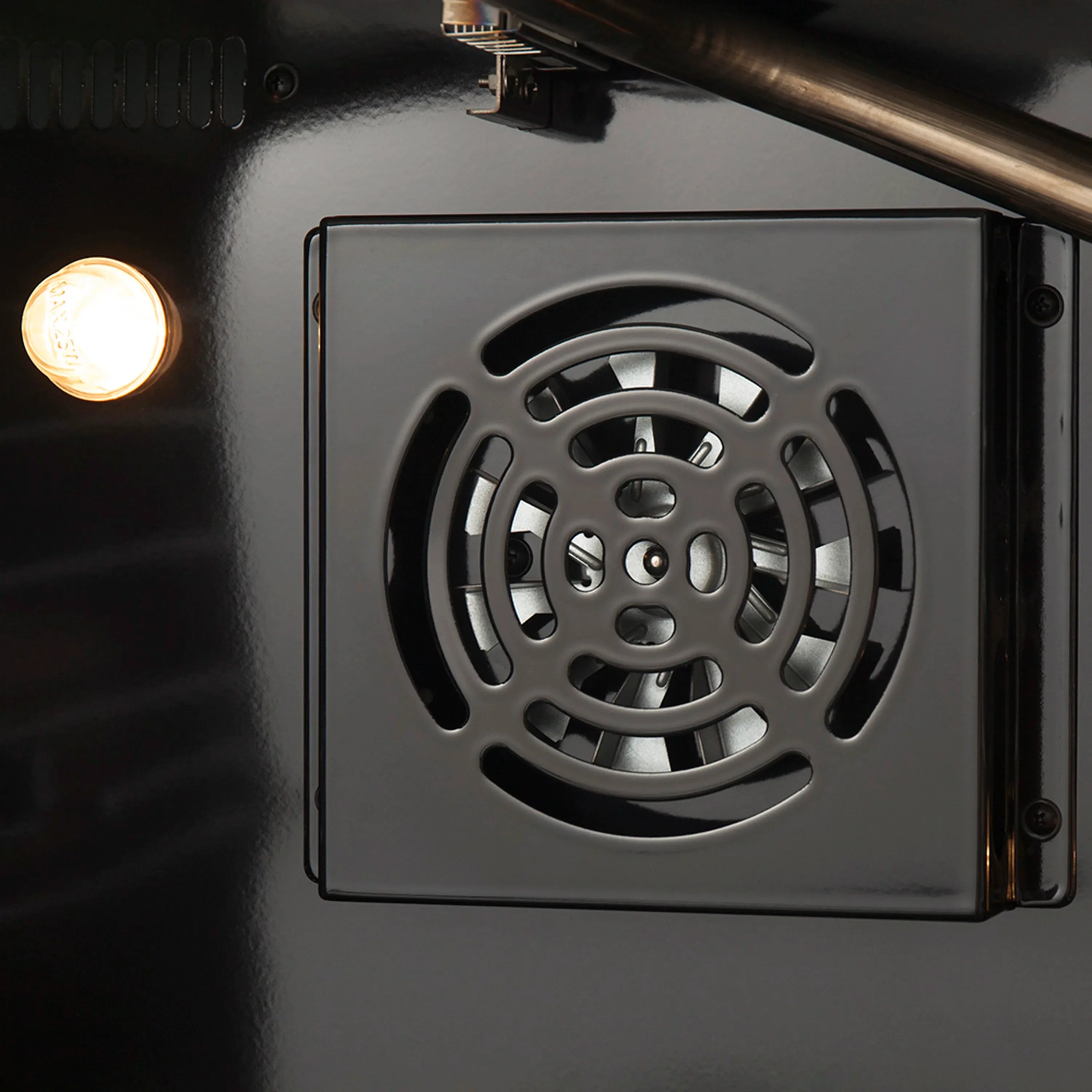 Microwave oven vent fan cover with circular grille