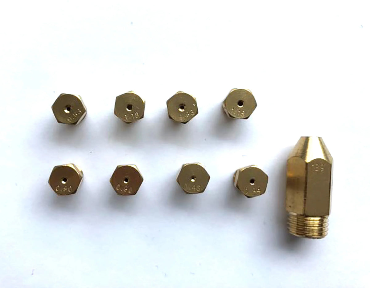 Gas range burner orifices and igniter tip assembly in brass