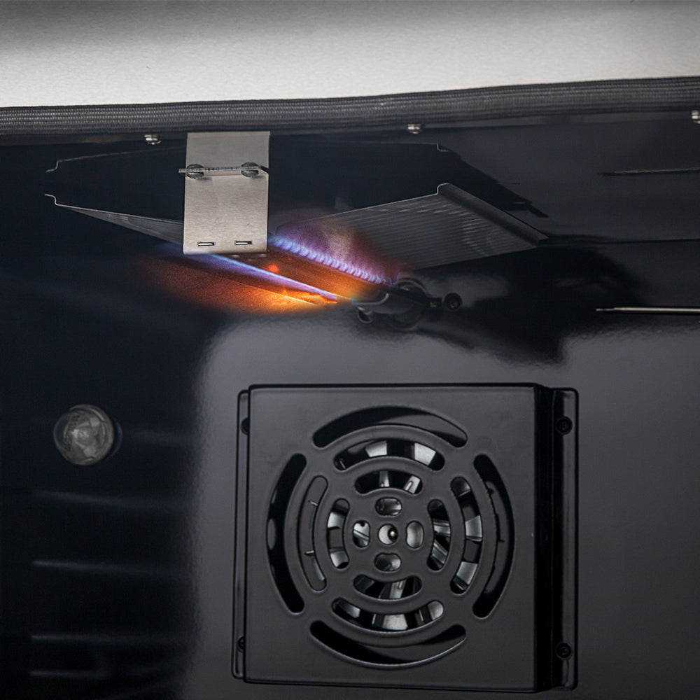 Gas oven burner flame beneath a black burner grate and igniter plate