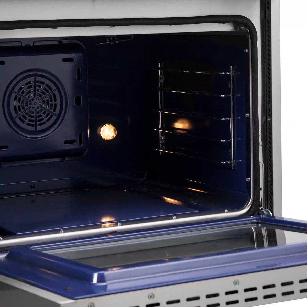 Open dual fuel oven door with racks inside and lower warming tray, blue interior.