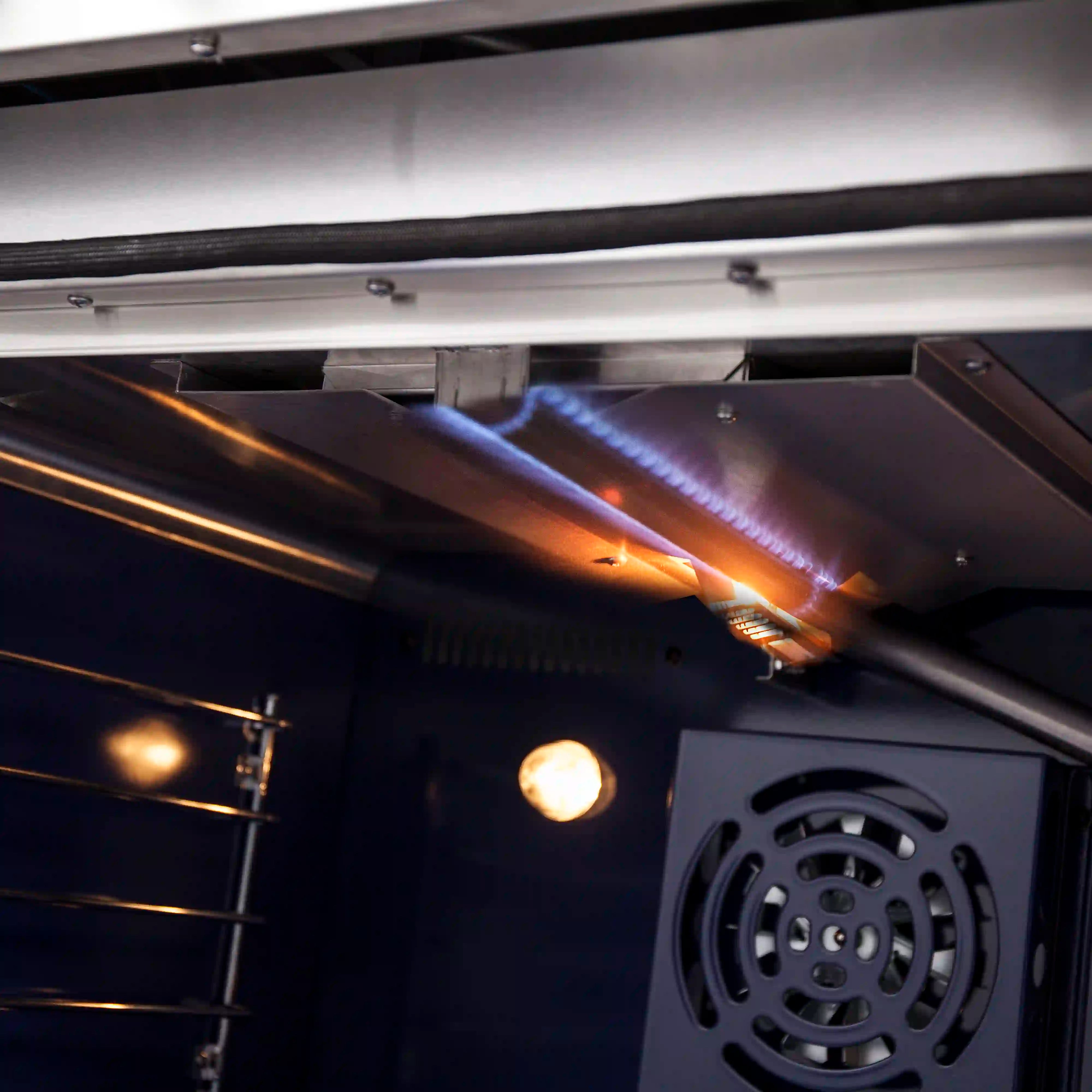 Gas oven burners and ignition tube inside stainless oven