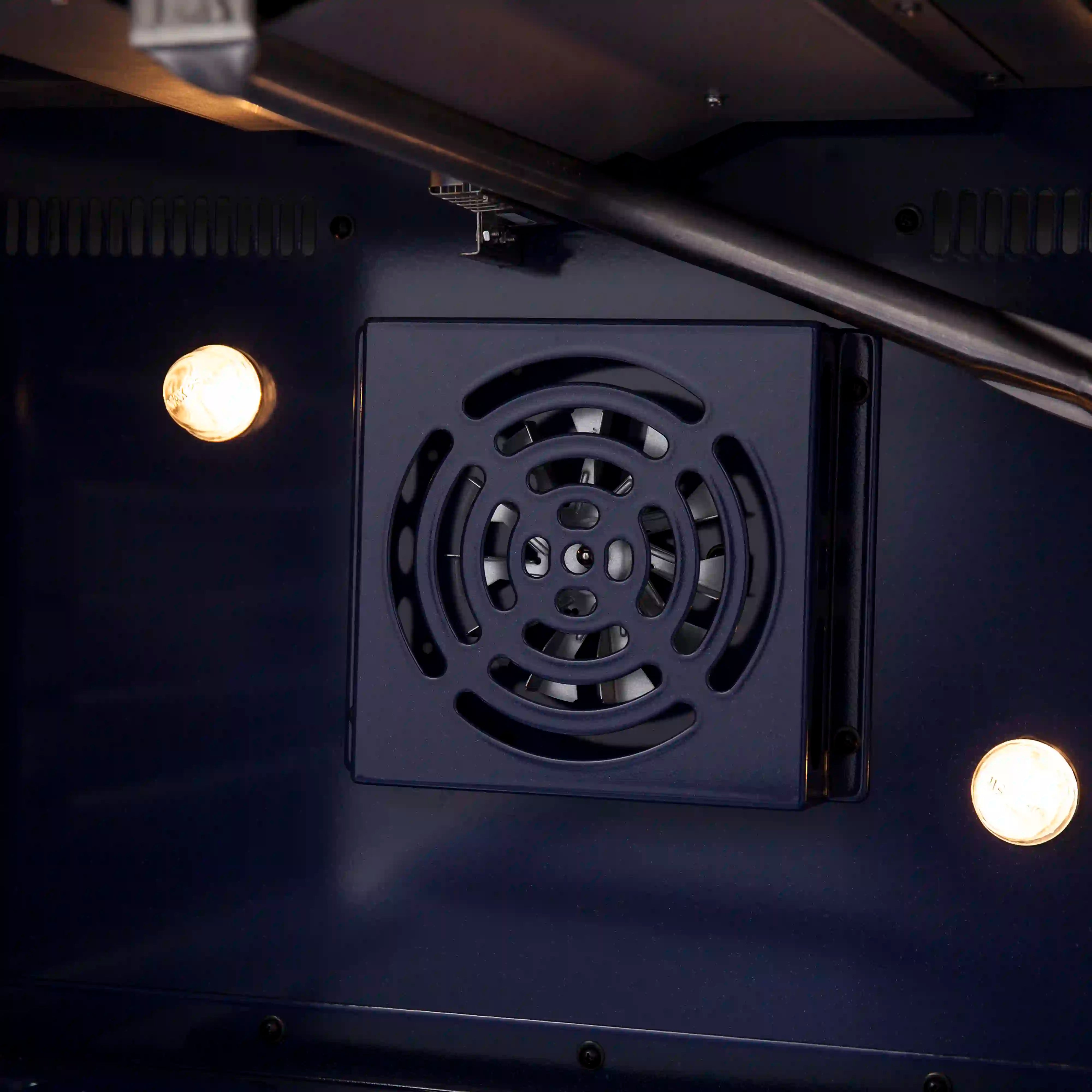 Gas range oven rear fan vent panel with circular fan grille