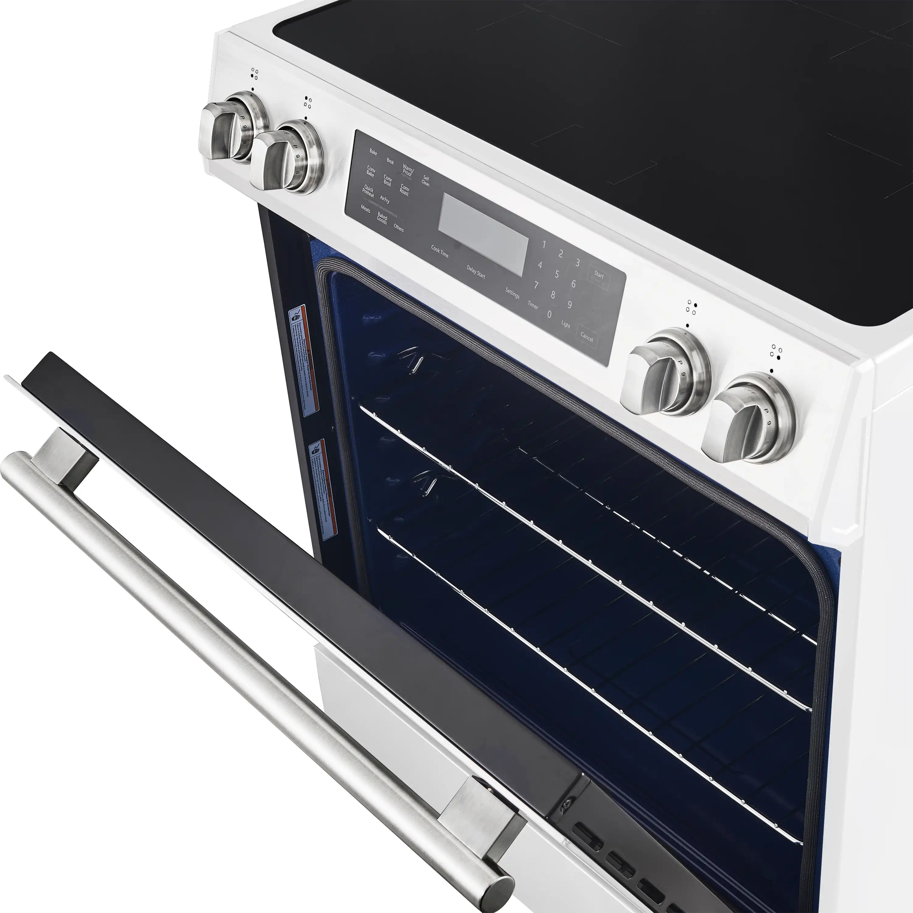 Open white induction range oven with racks and brass handle on front panel.
