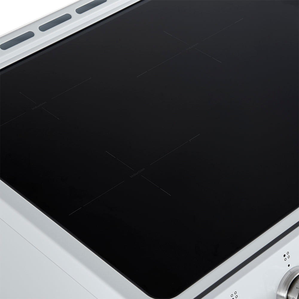Close-up of dark glass cooktop on a white induction range with touch controls