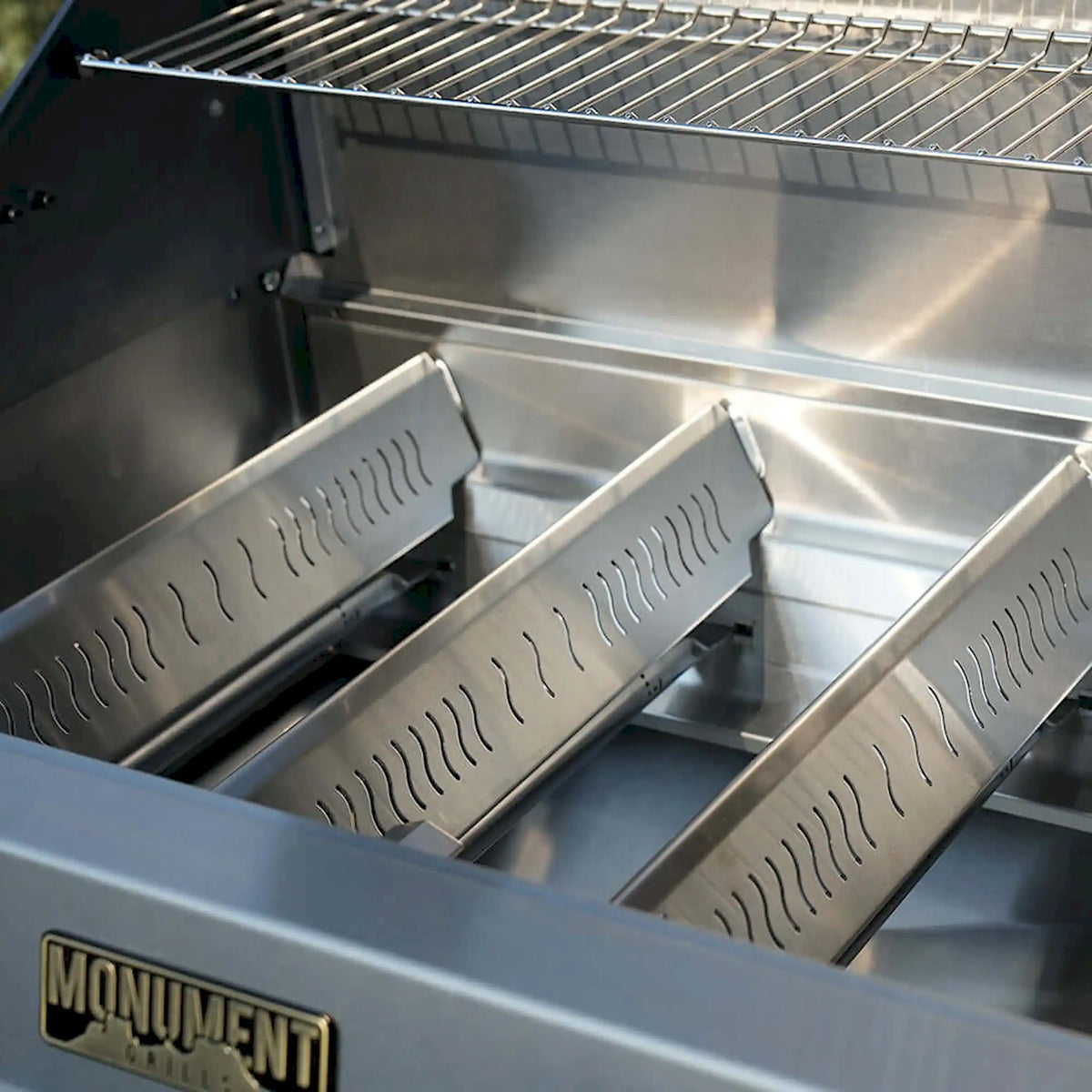 Open propane gas grill with stainless cooking grates and burner covers