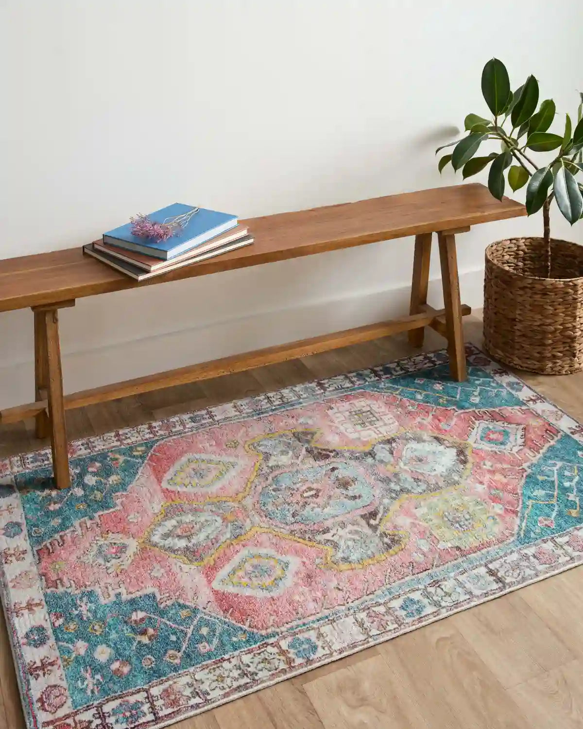 Teal, rust, and cream area rug with central medallion and ornate border