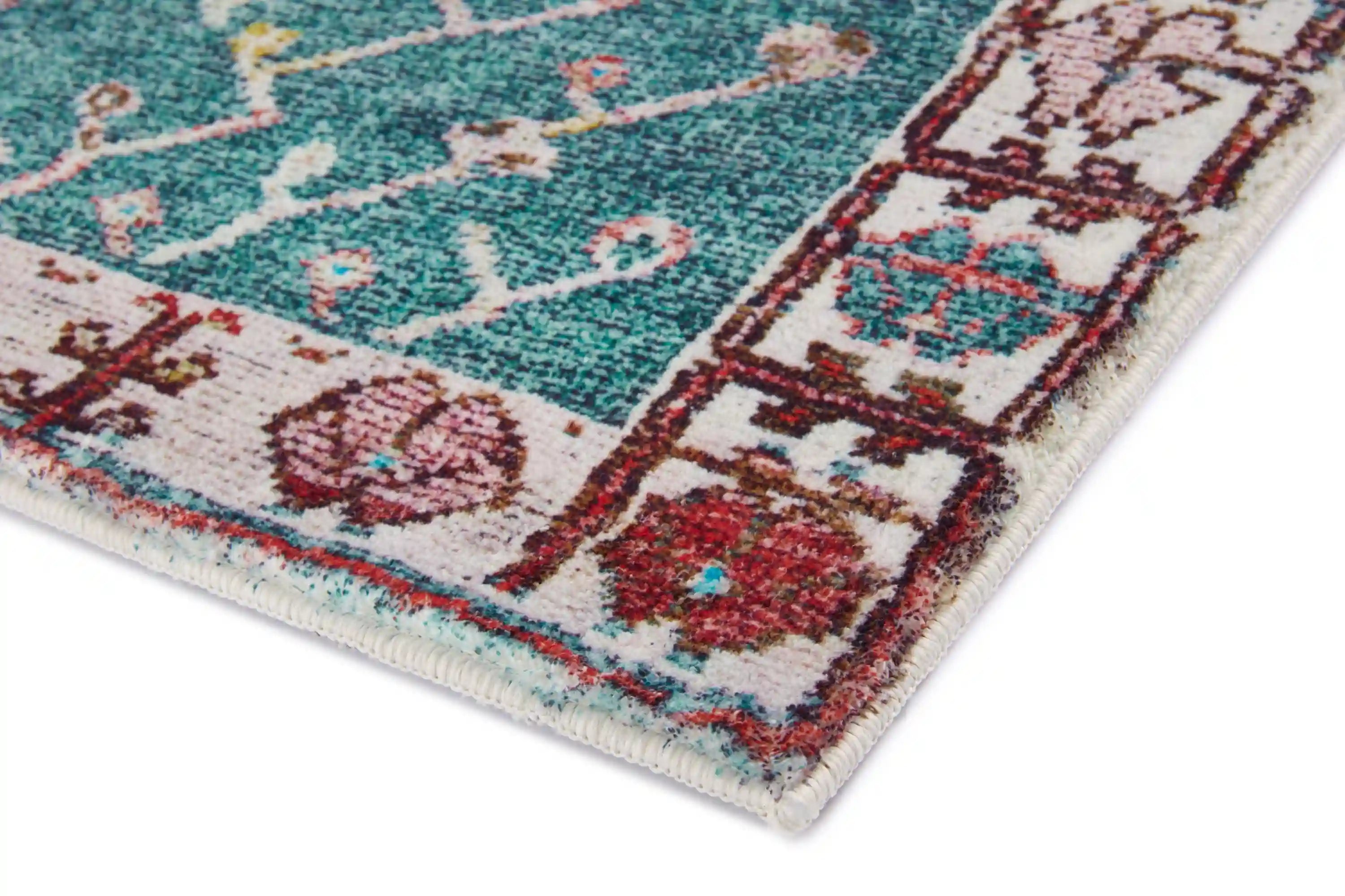 Rust and teal accent rug with cream medallion pattern and fringed edges