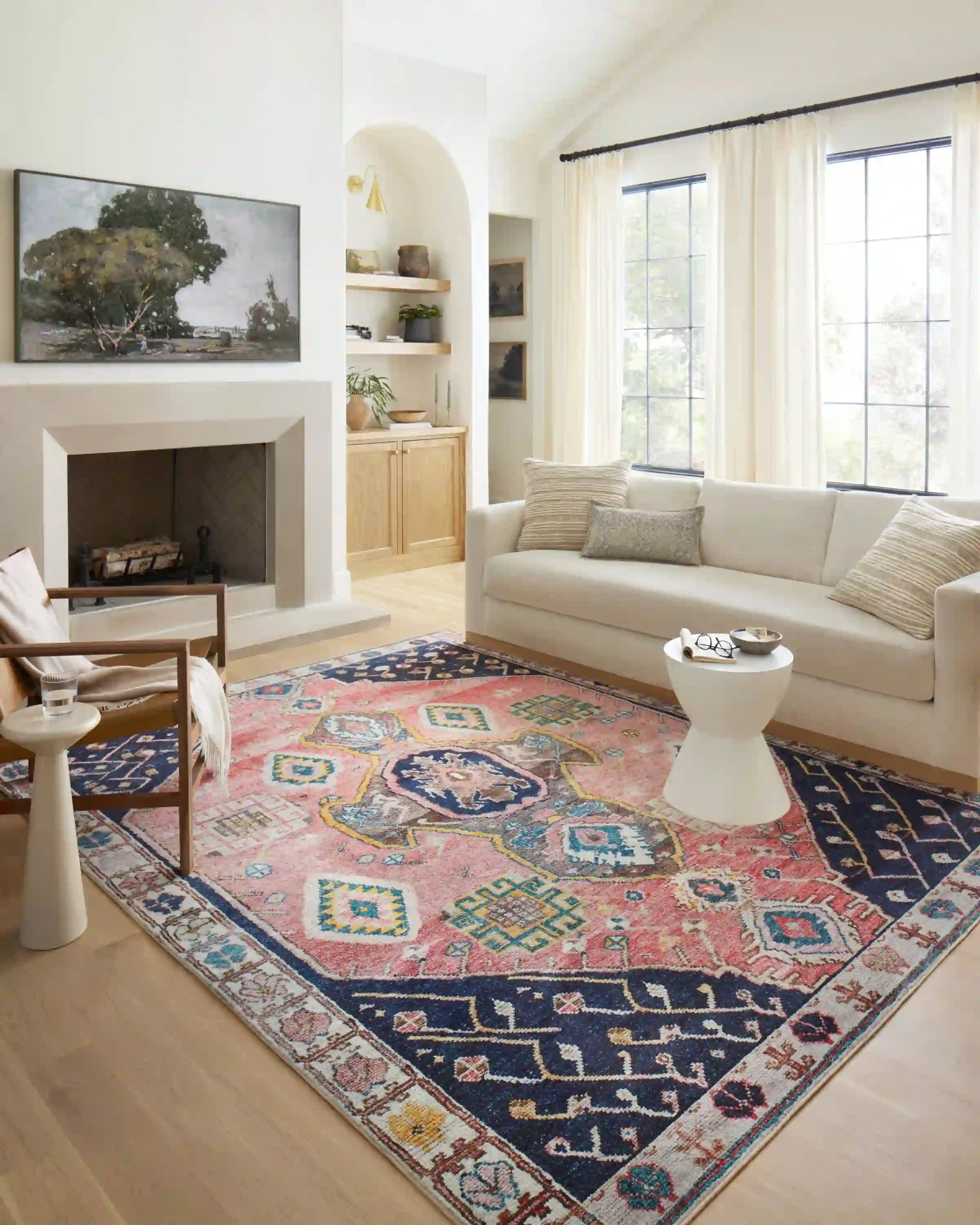 Multicolor geometric area rug laid flat with navy and rust patterns across the surface