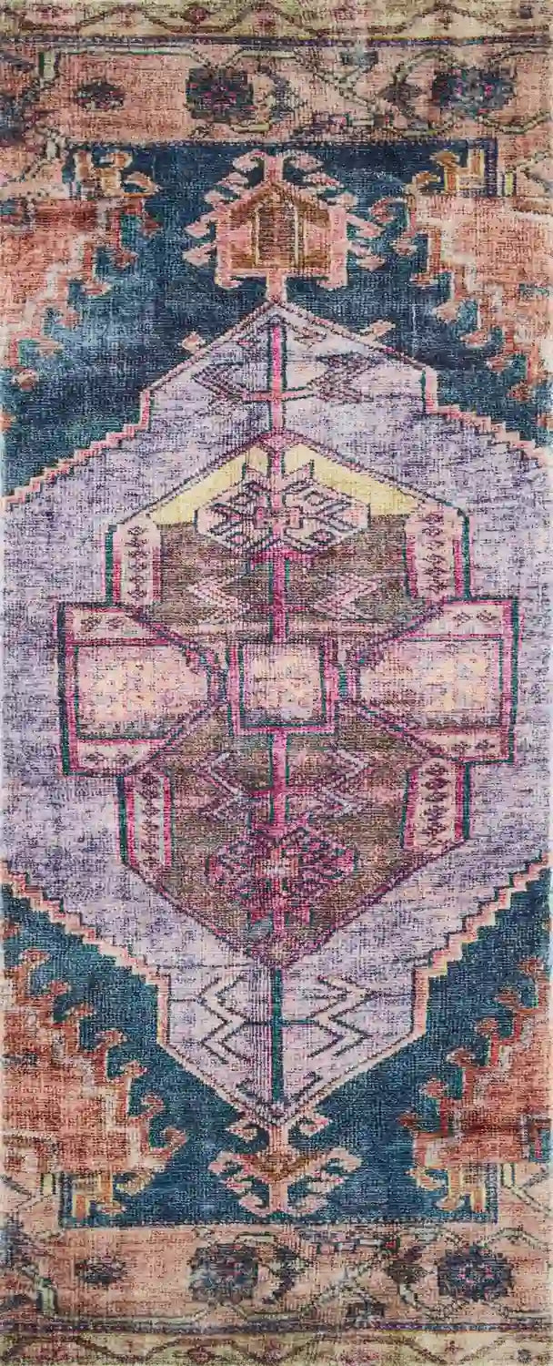 Accent rug close-up with ornate navy, lilac, and rust geometric motif and border