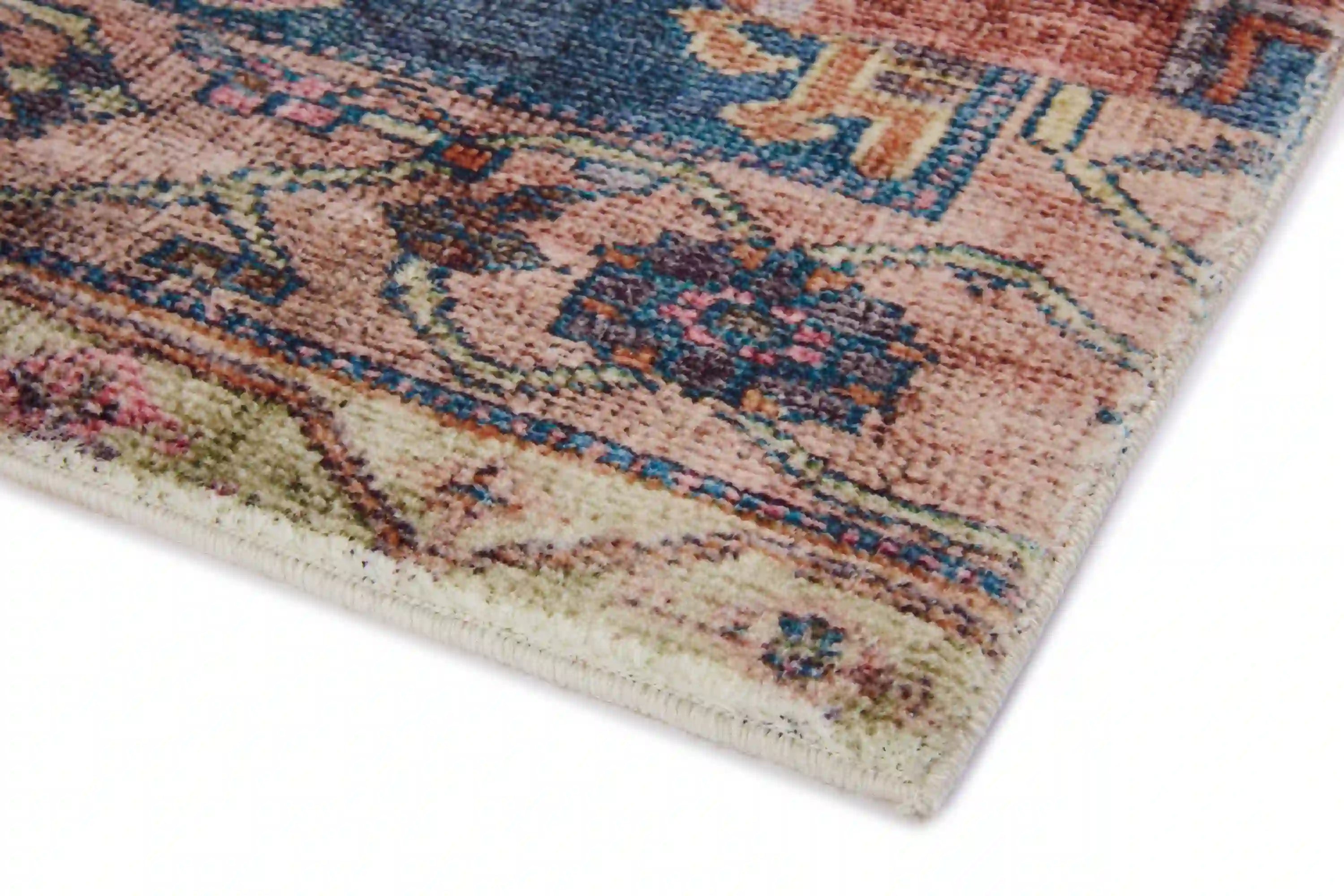 Accent rug corner detail with low-pile distressed multicolor weave and light border
