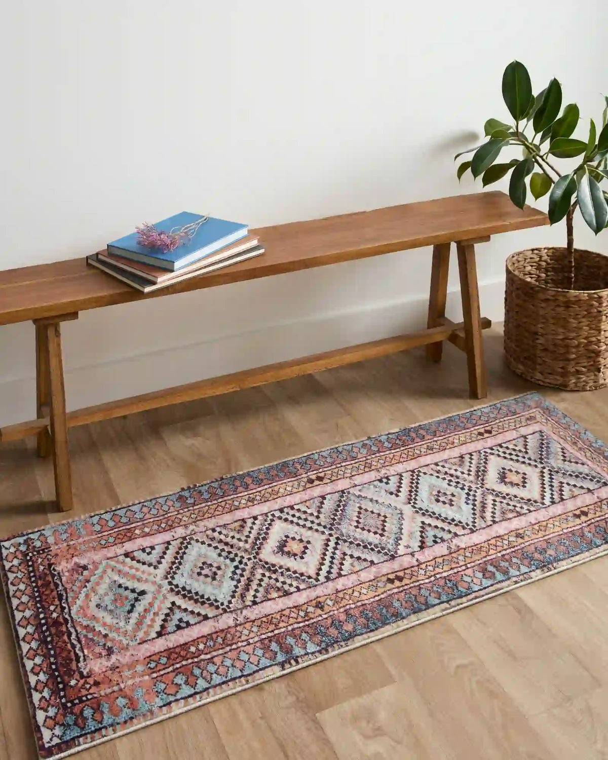 Geometric runner-style rug with blue border and coral details, 2' x 5'