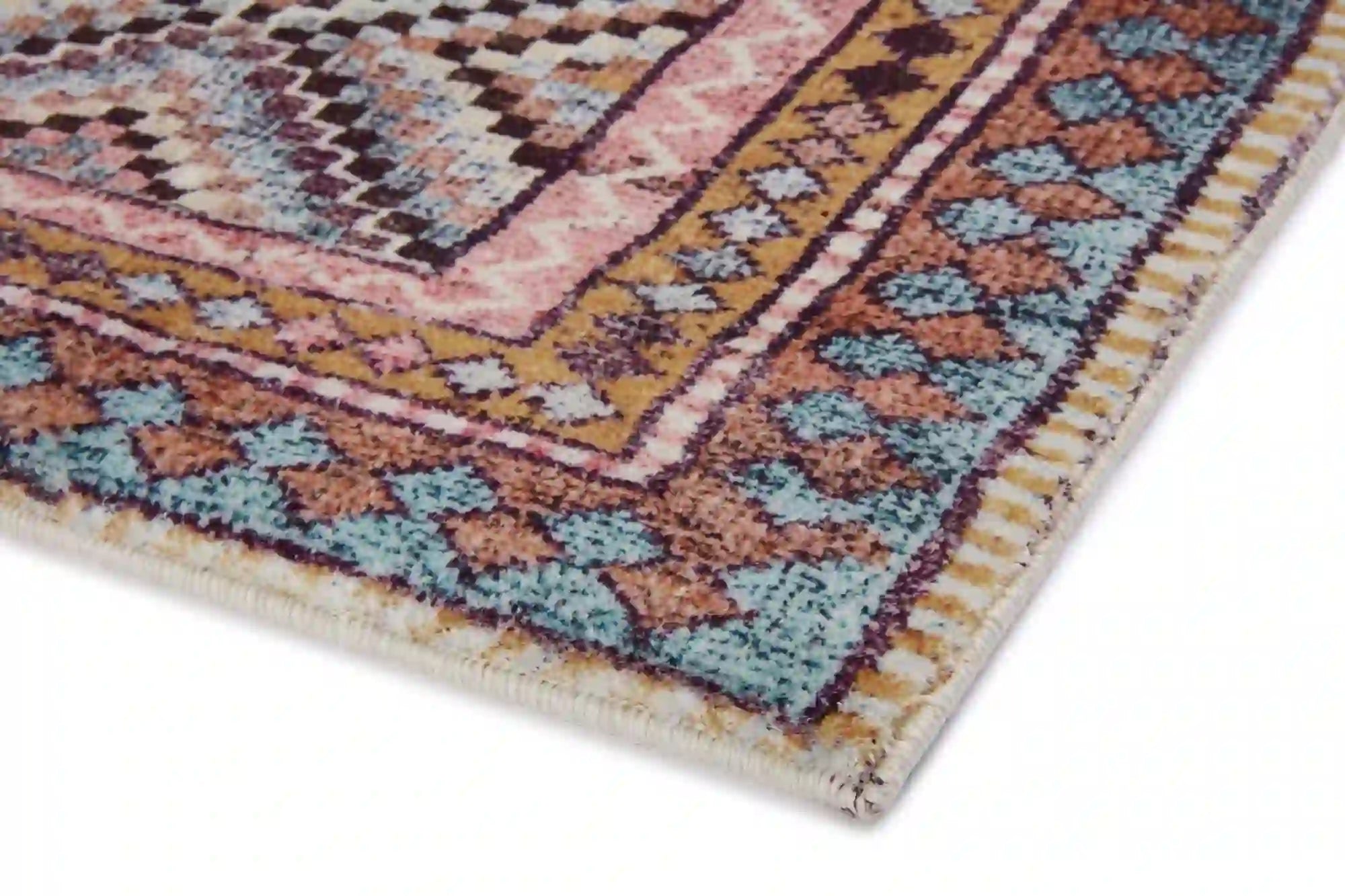 Close-up geometric accent rug corner, multicolor pattern with fringed edges