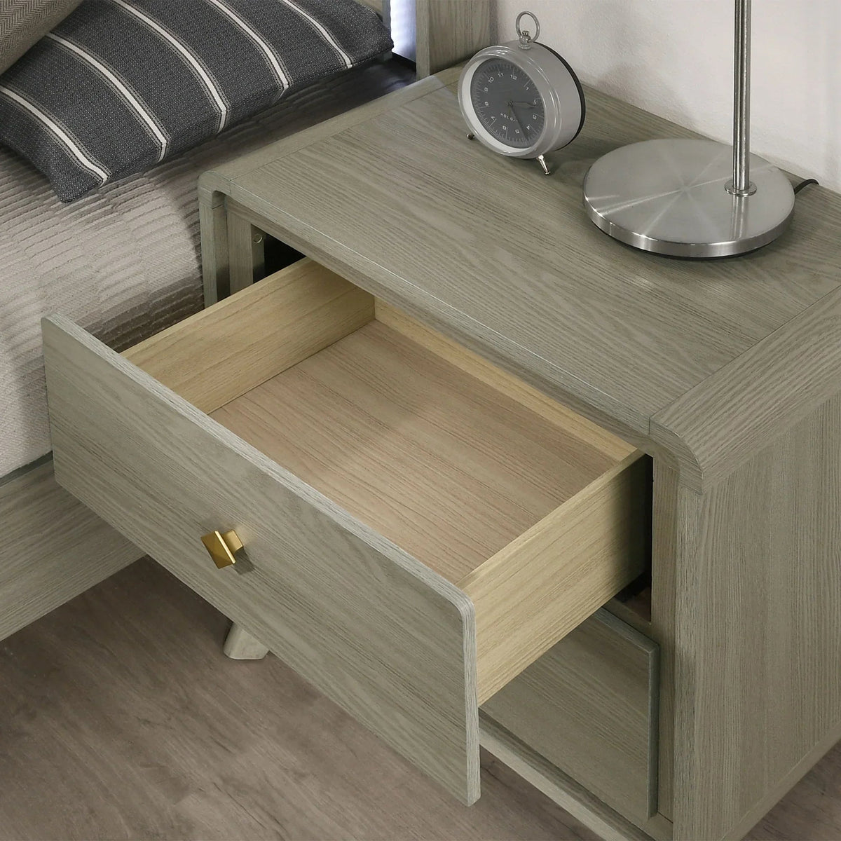 Gray wood nightstand with open drawer showing smooth interior and gold hardware