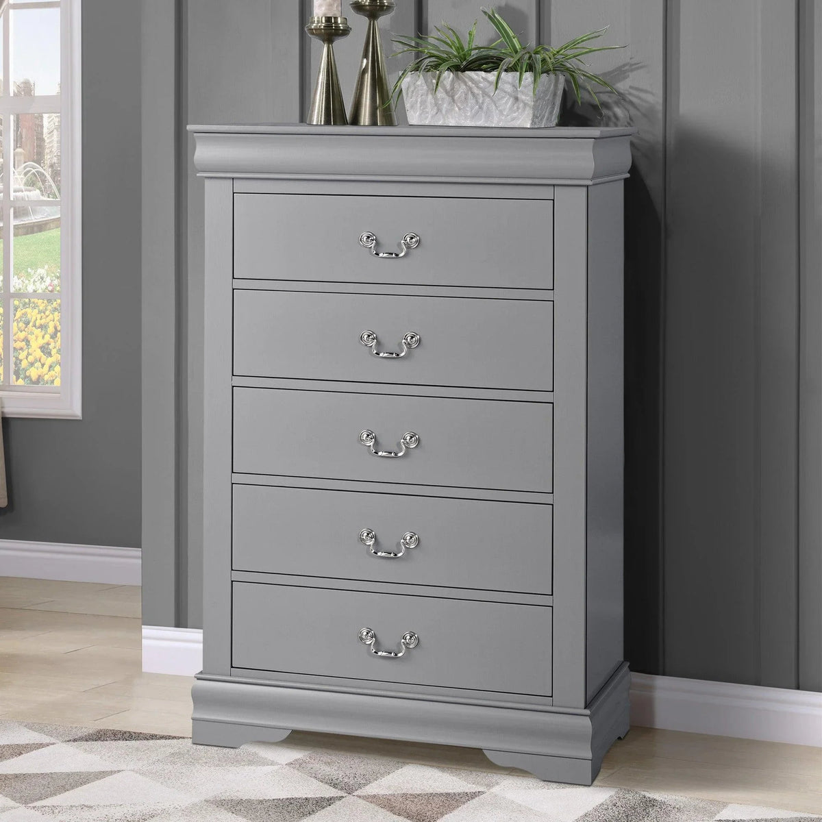 Light gray chest of drawers with five drawers, curved metal pulls, and bracket feet.