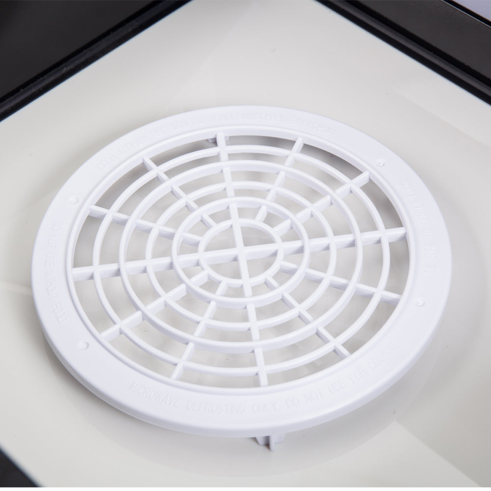 White circular vent cover inside microwave drawer cavity