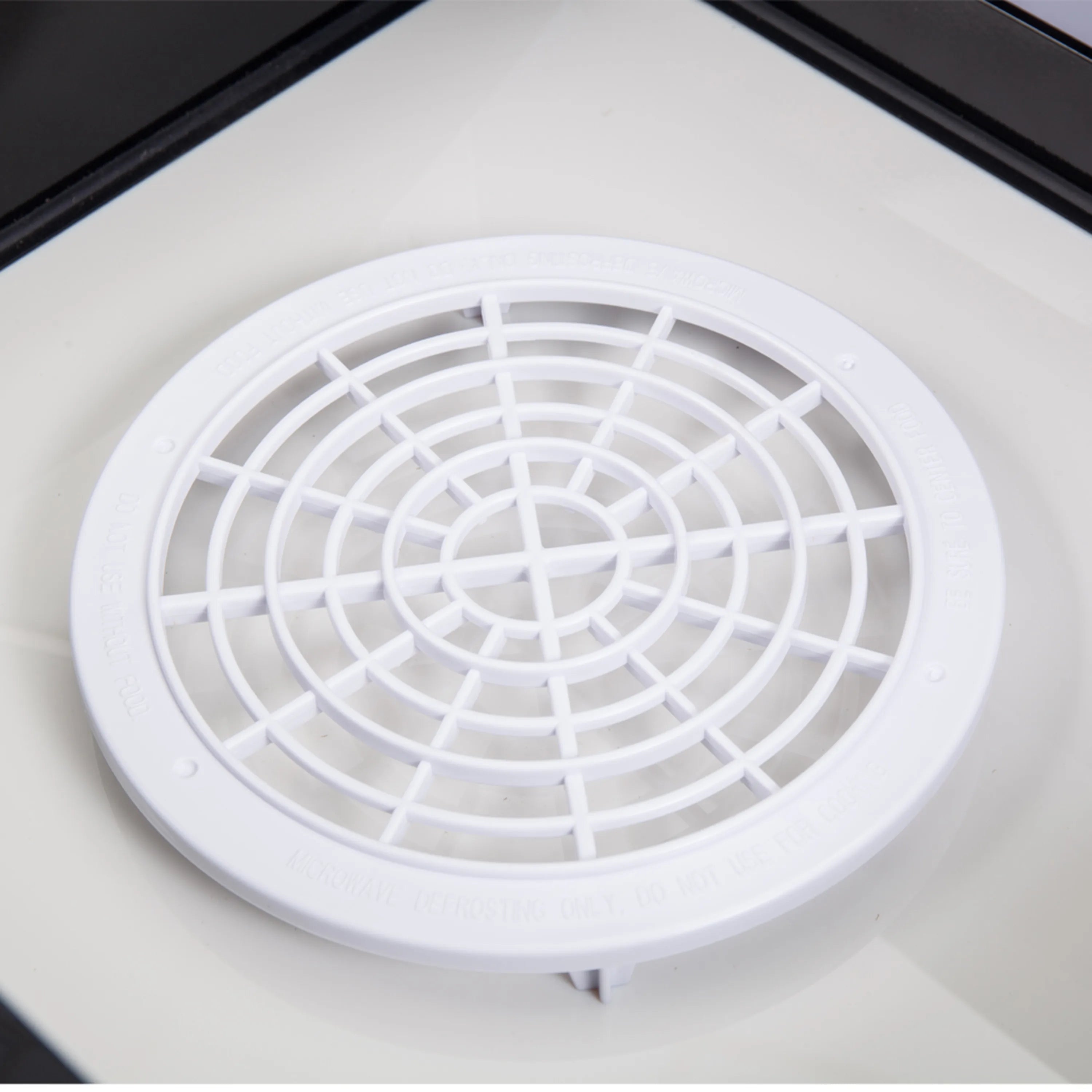 Microwave drawer interior airflow grille with circular fan cover