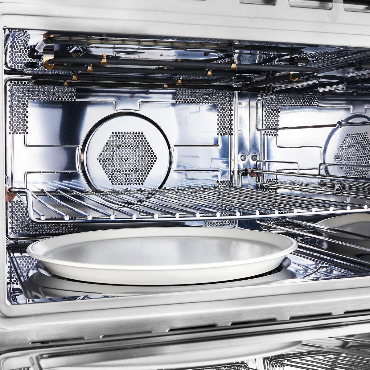 Open microwave oven interior with glass turntable and metal cooking rack
