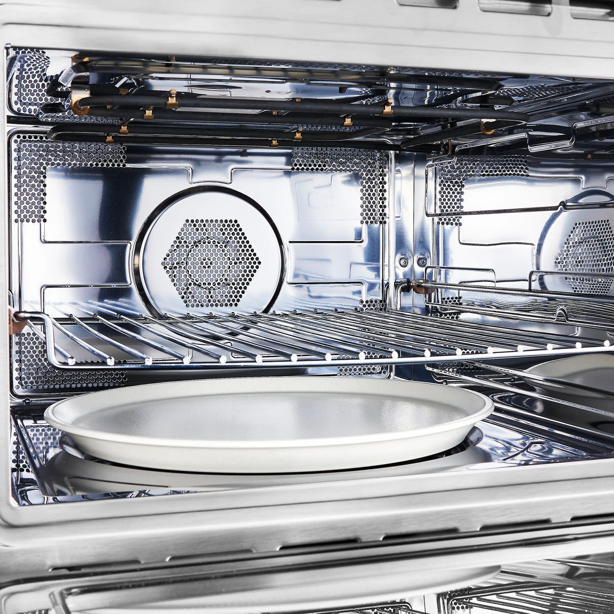 Stainless steel dishwasher interior with top spray area and a loading rack, close view