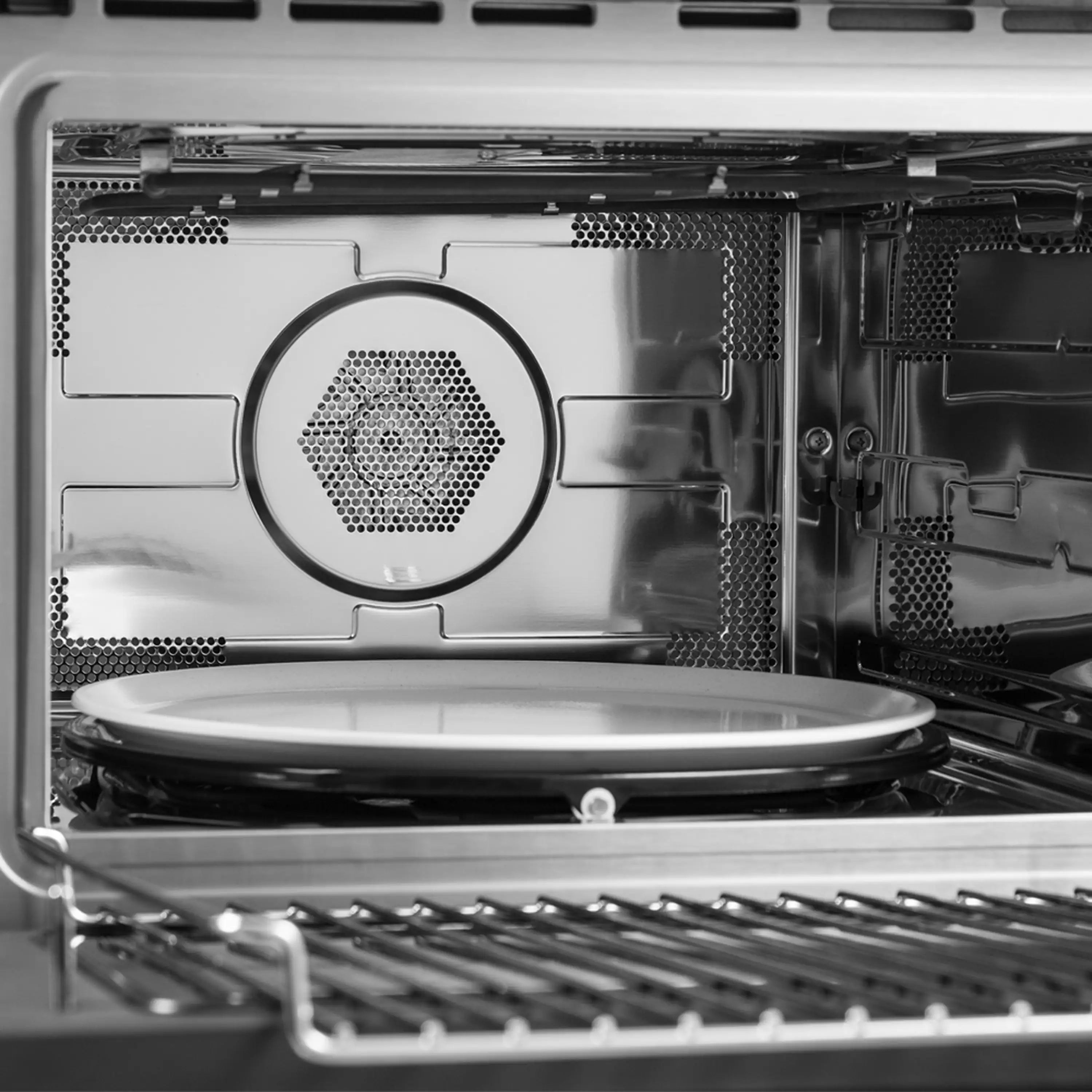 Stainless steel microwave oven interior with circular turntable plate