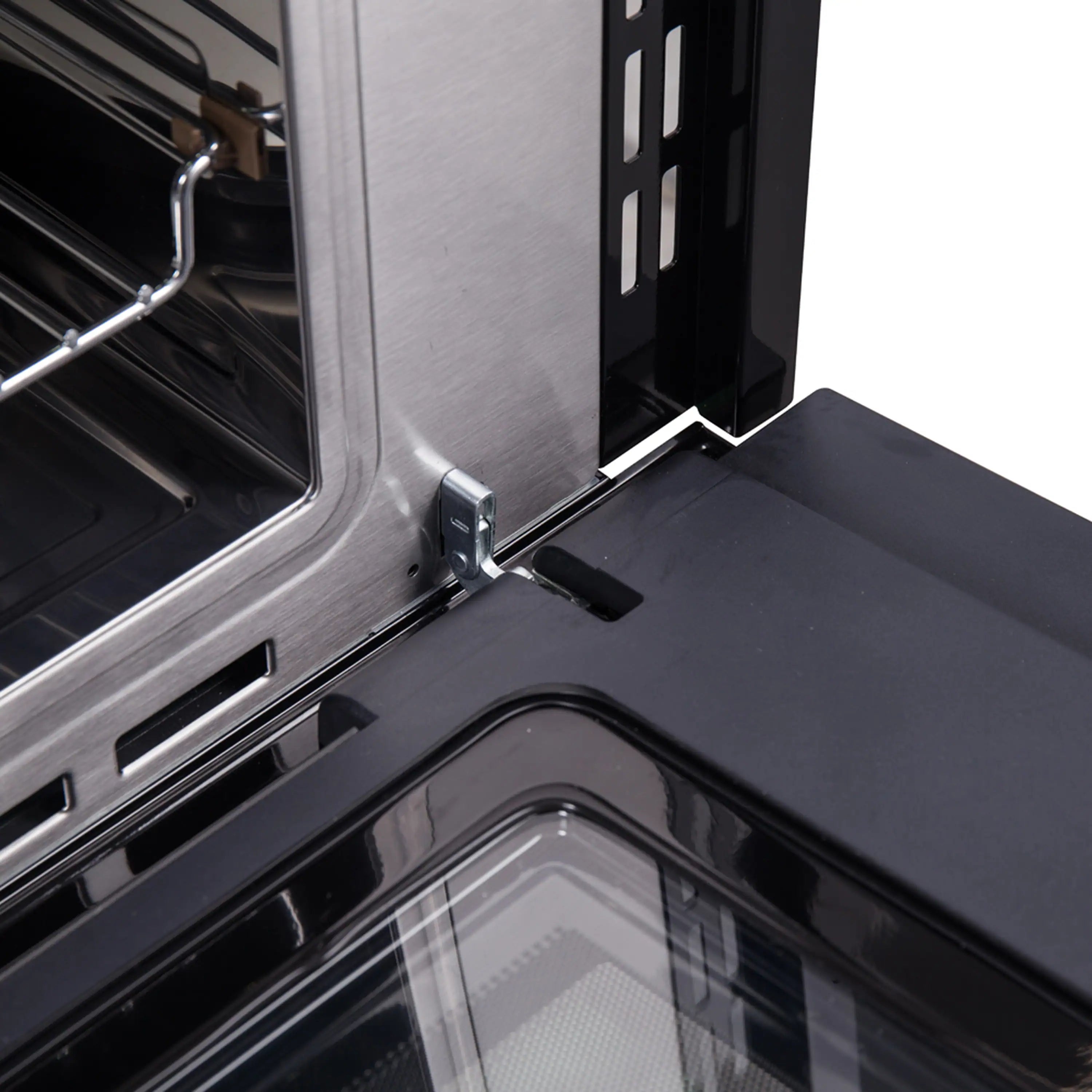 Wall oven door hinge area and side vent controls inside stainless steel frame