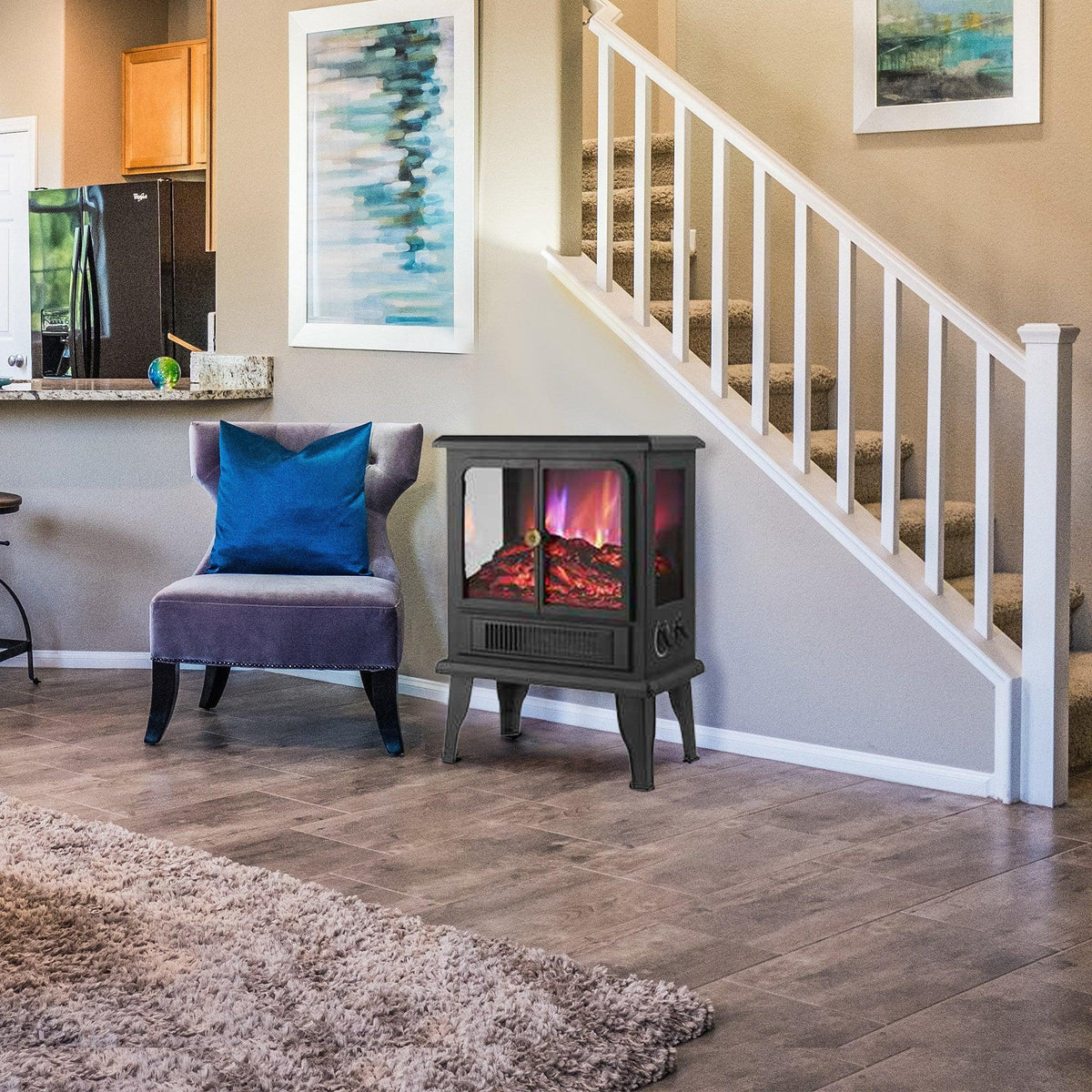 Black freestanding electric fireplace heater in a living room beside an upholstered chair