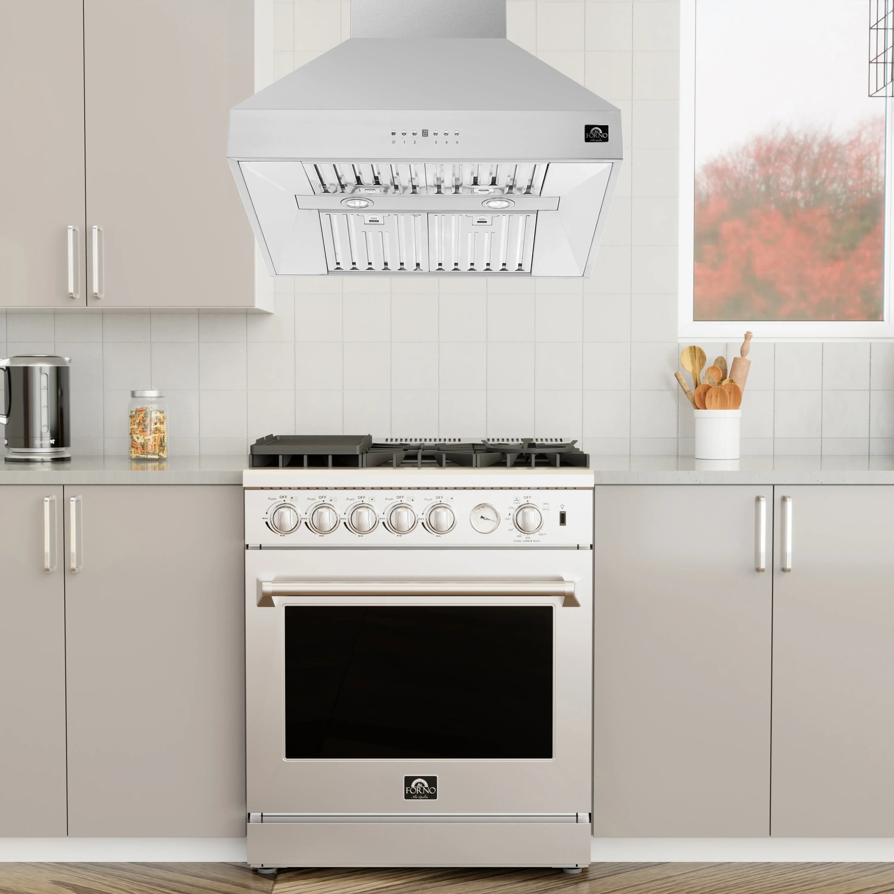 Stainless steel wall range hood over a gas range with control panel and oven door