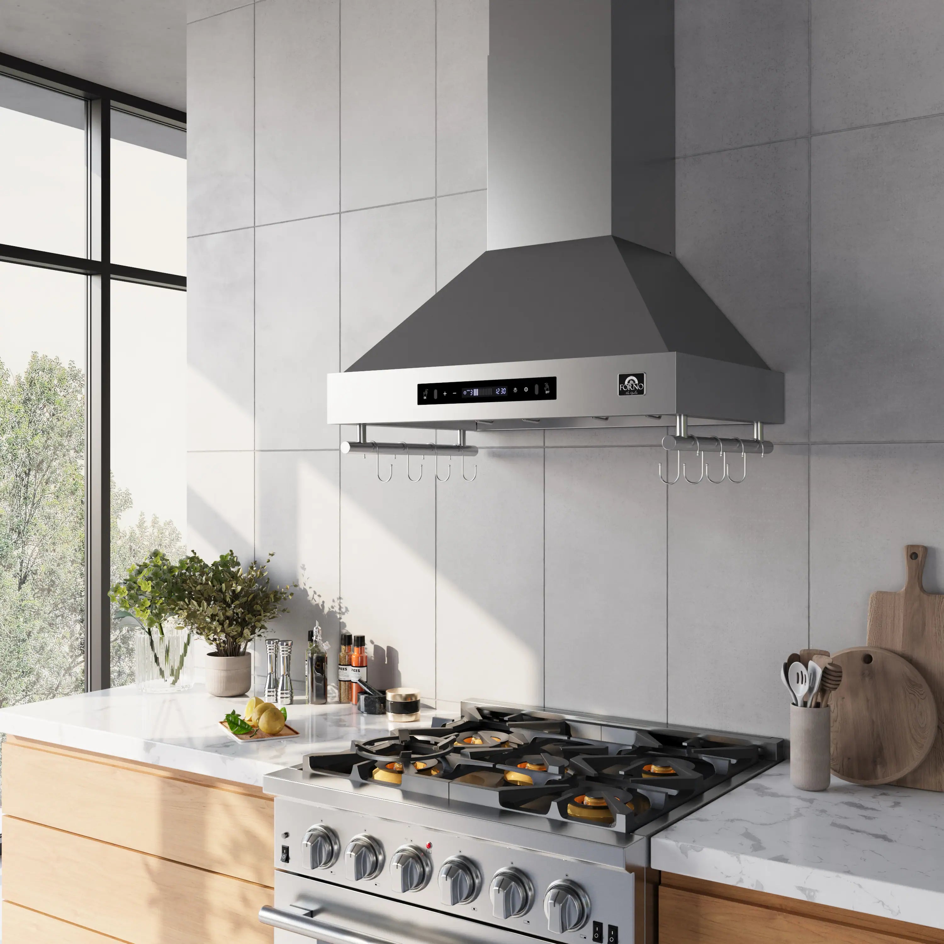 Stainless steel wall range hood above gas cooktop with hanging utensil hooks