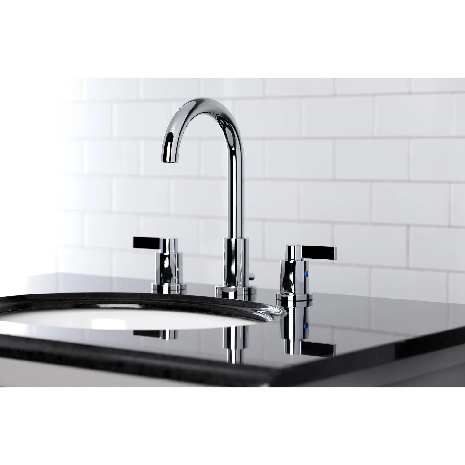 Polished chrome widespread bathroom faucet with three handles on countertop
