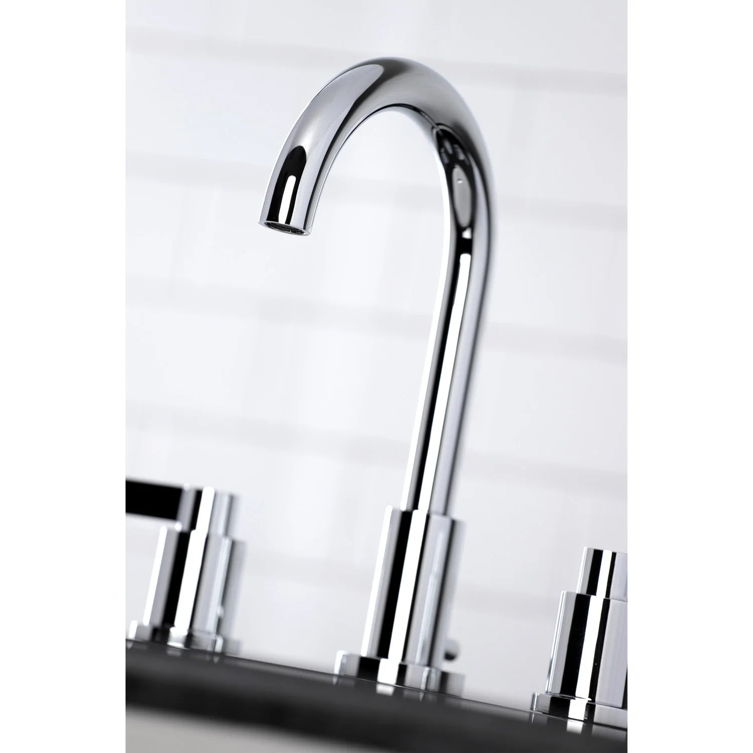 Polished chrome curved bathroom faucet spout over sink