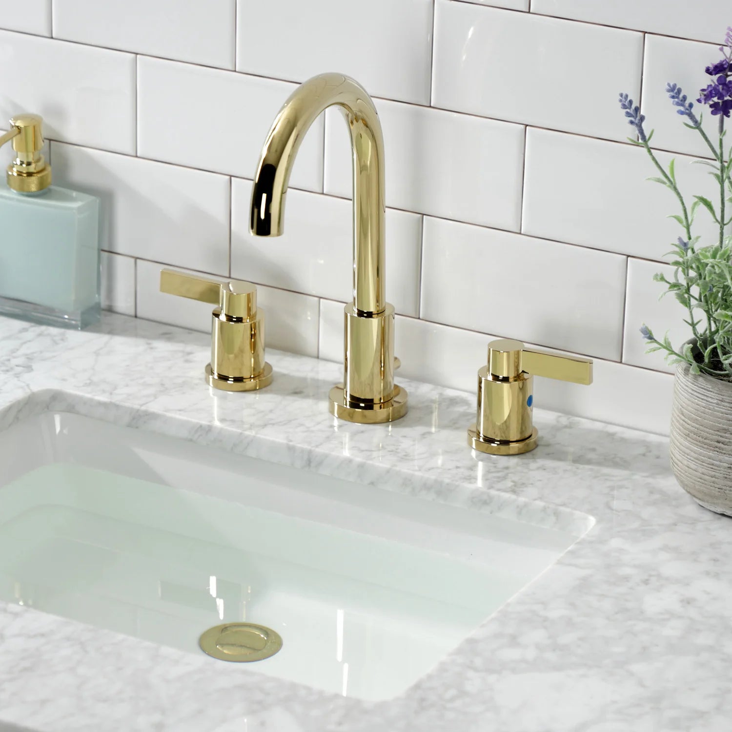 Polished brass widespread bathroom faucet with pop-up drain and arched spout