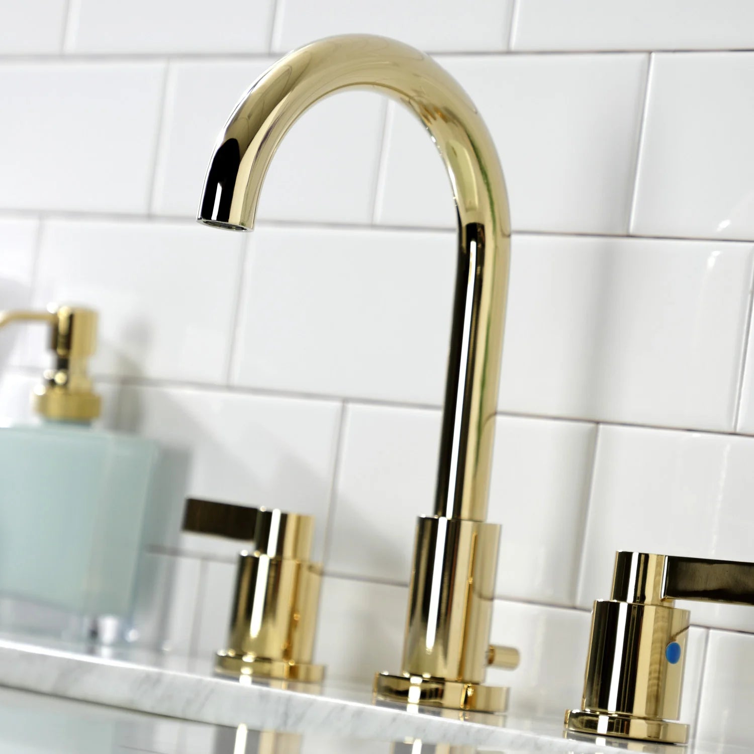 Polished brass bathroom faucet spout with deck-mounted cross handles