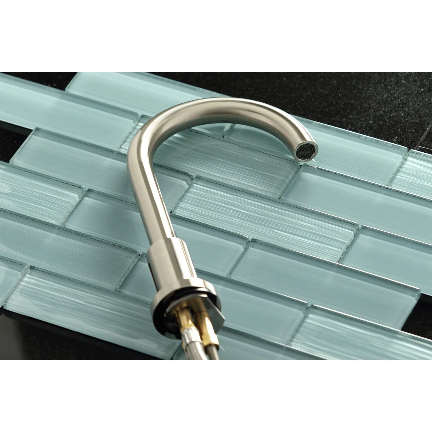 Brushed nickel faucet spout with aerator detail and arched outlet
