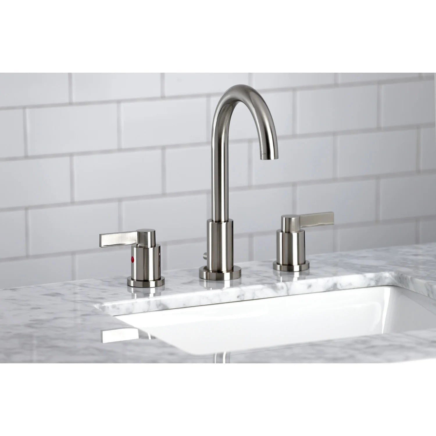 Brushed nickel widespread faucet with arched spout and matching deck handles over sink