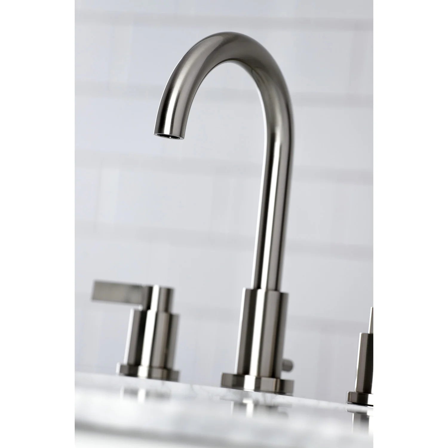 Brushed nickel widespread bathroom faucet with arched spout and side lever handles