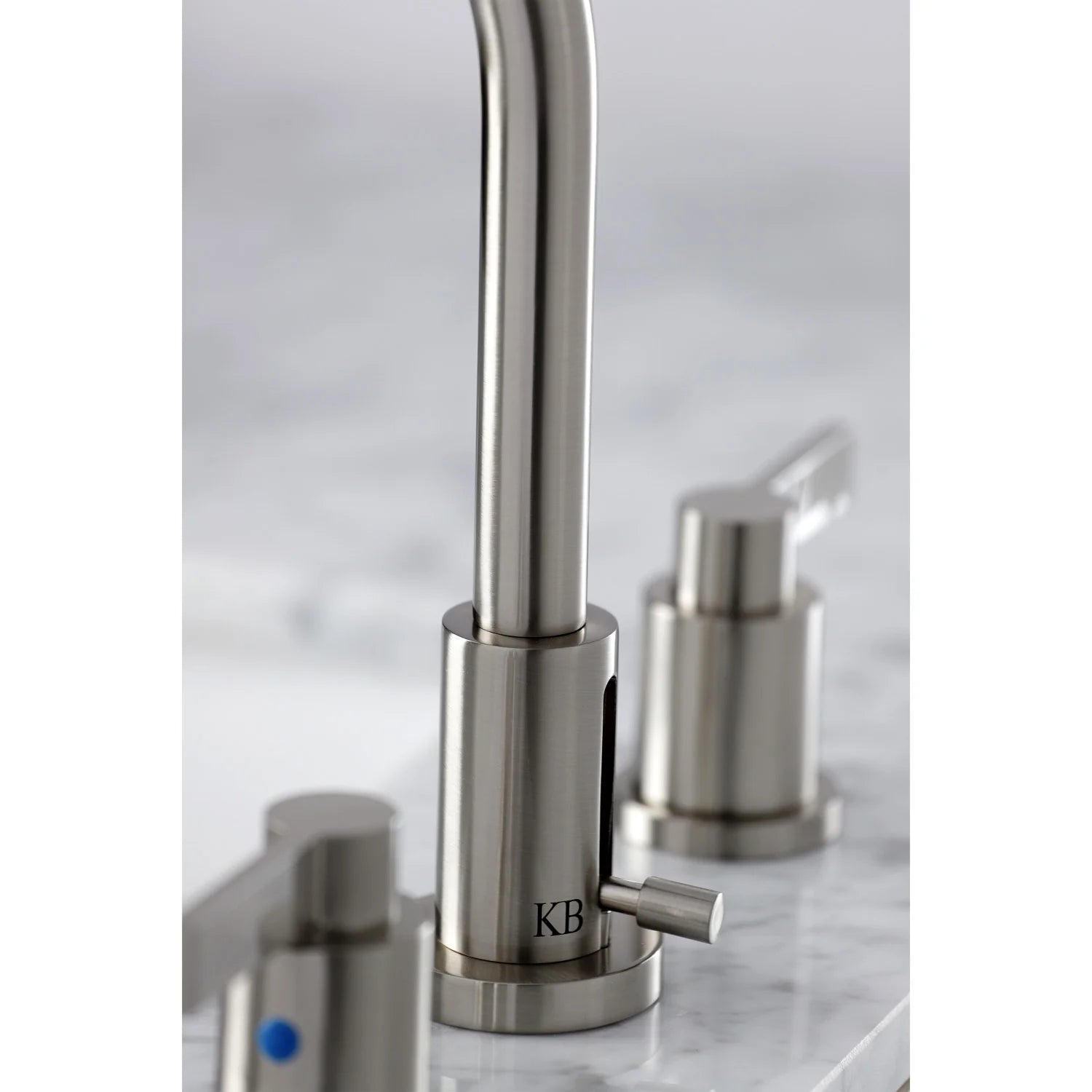 Brushed nickel widespread faucet with cylindrical handle controls and arched spout