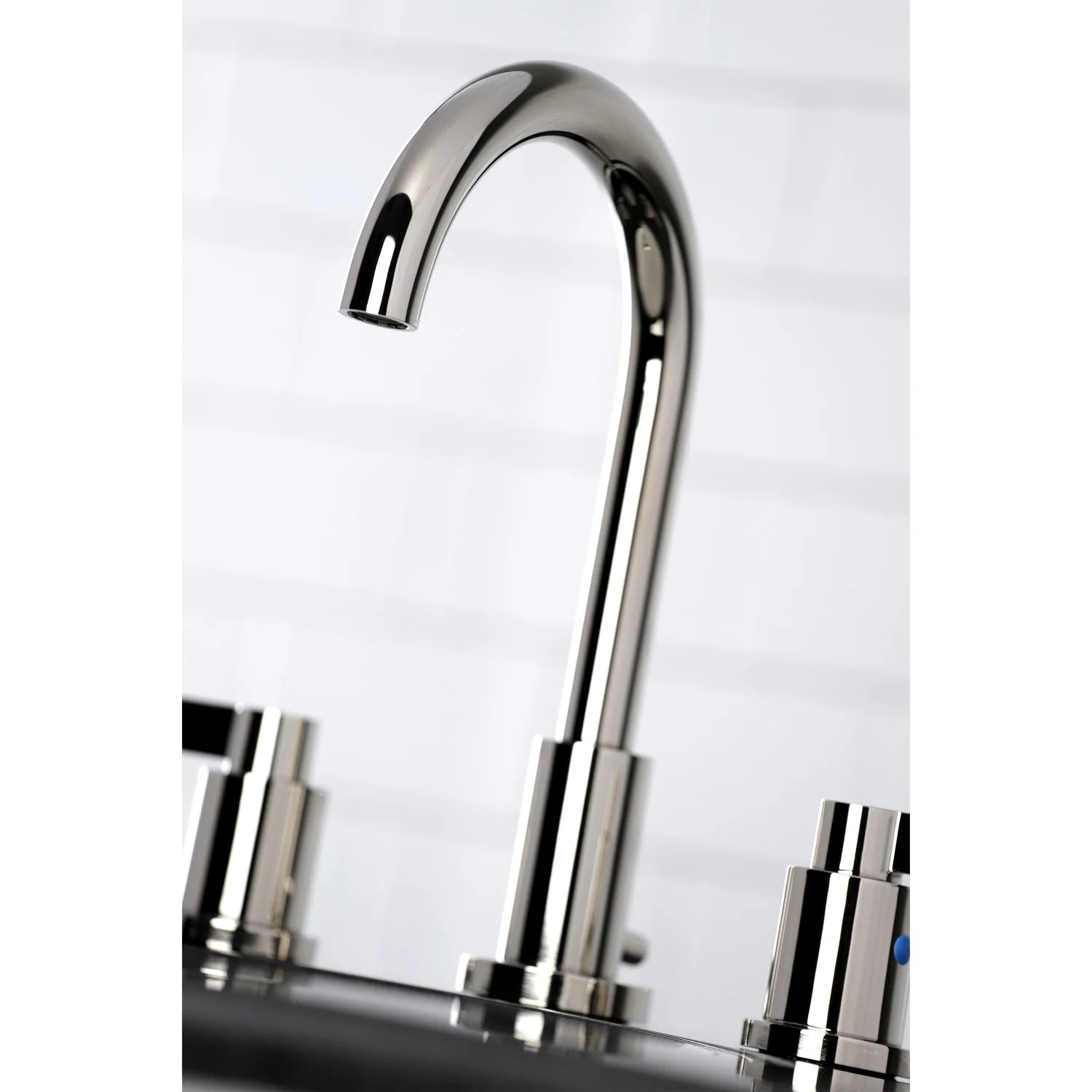 Polished nickel arched faucet spout with glossy finish and widespread handle bases