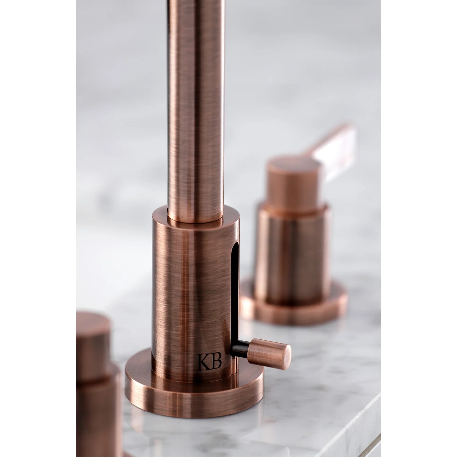Antique copper widespread faucet, close-up of tall spout base and lever handles