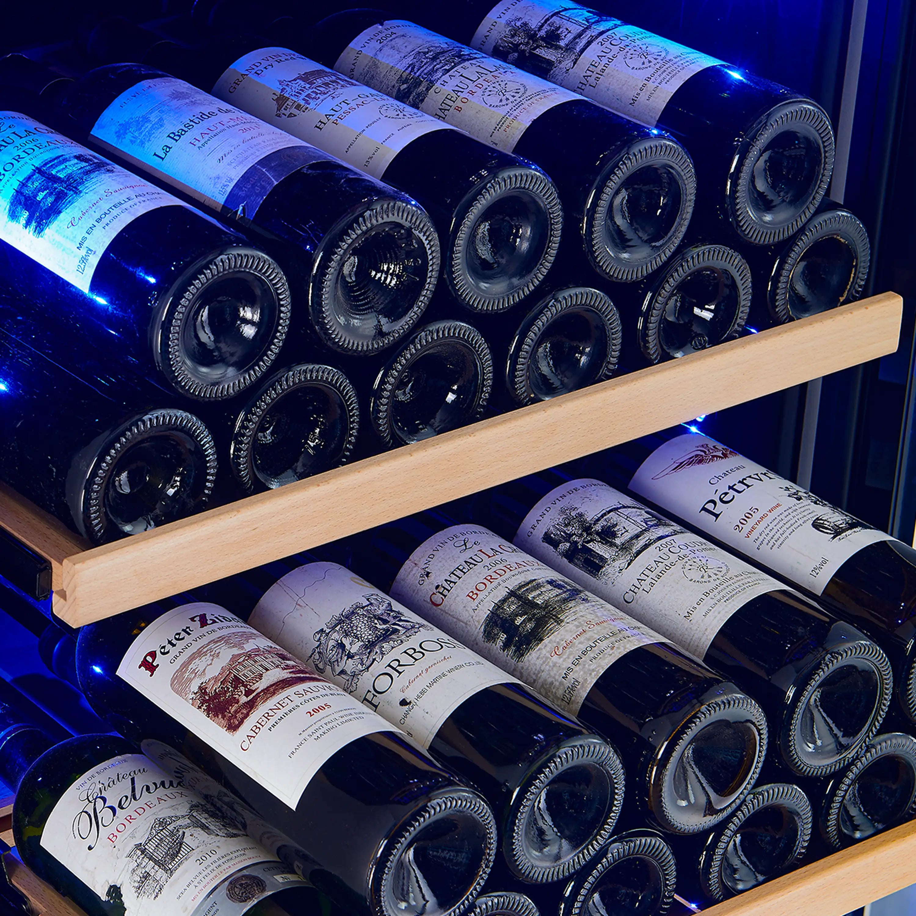 Wine cooler interior with bottles on wooden shelves under blue LED lighting