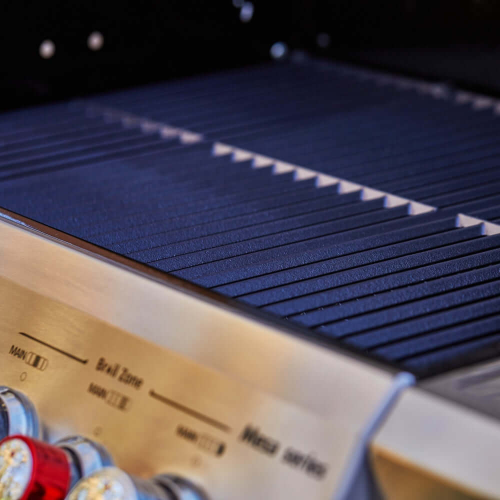 Stainless steel grill grates with dark ridged cooking surface inside the open lid