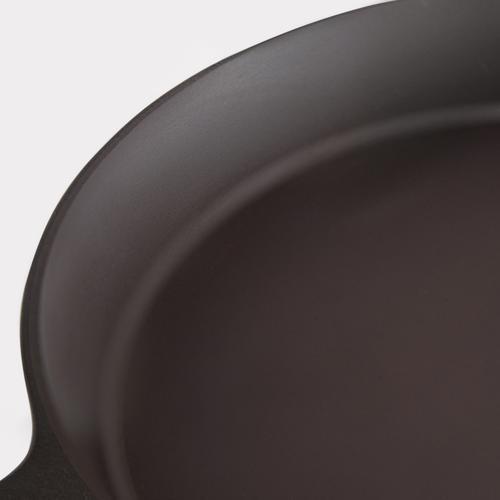 Close-up of black cast iron skillet interior surface