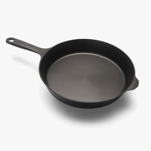 Dark cast iron frying pan with long handle and helper loop