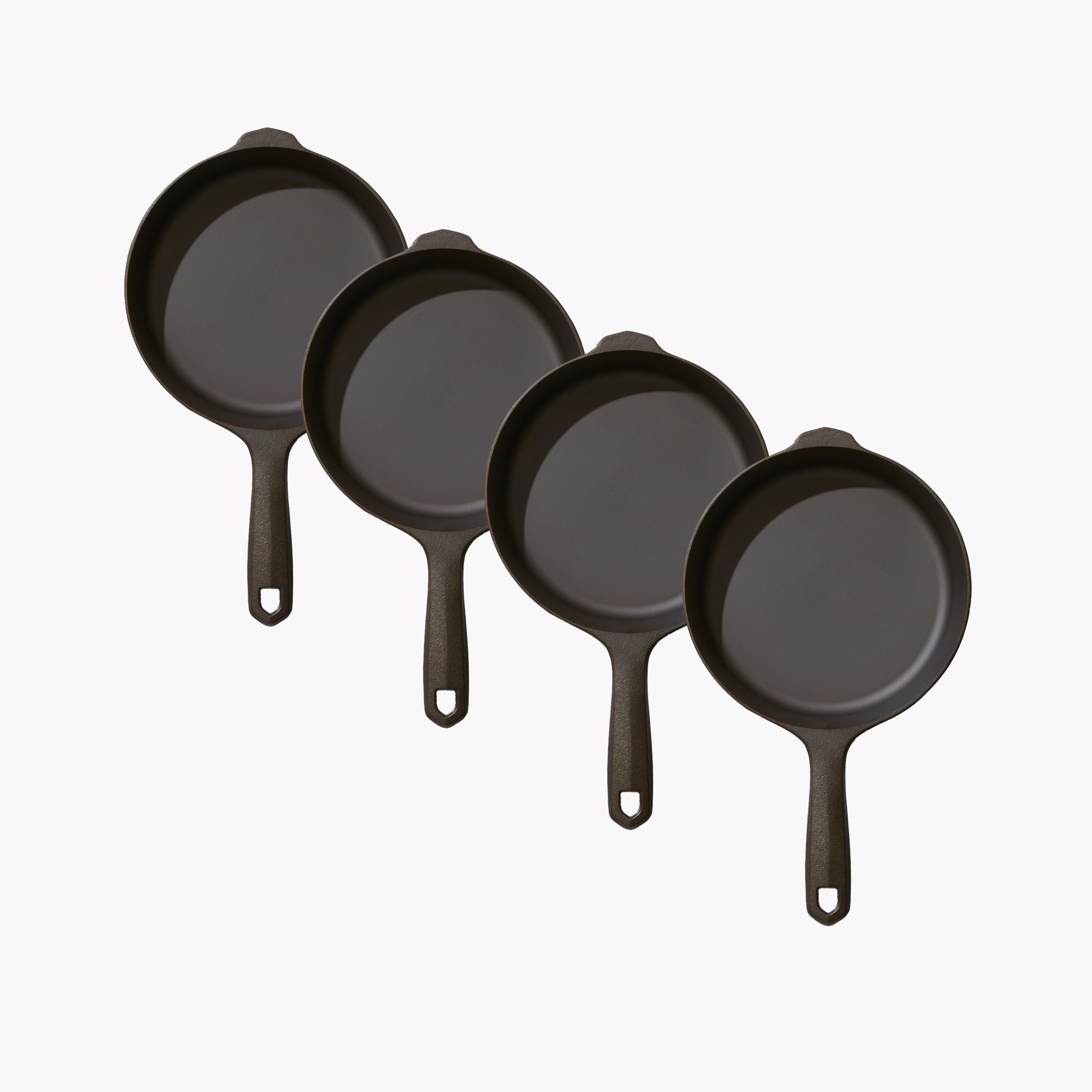 Set of four dark 6¾-inch skillets with short handles