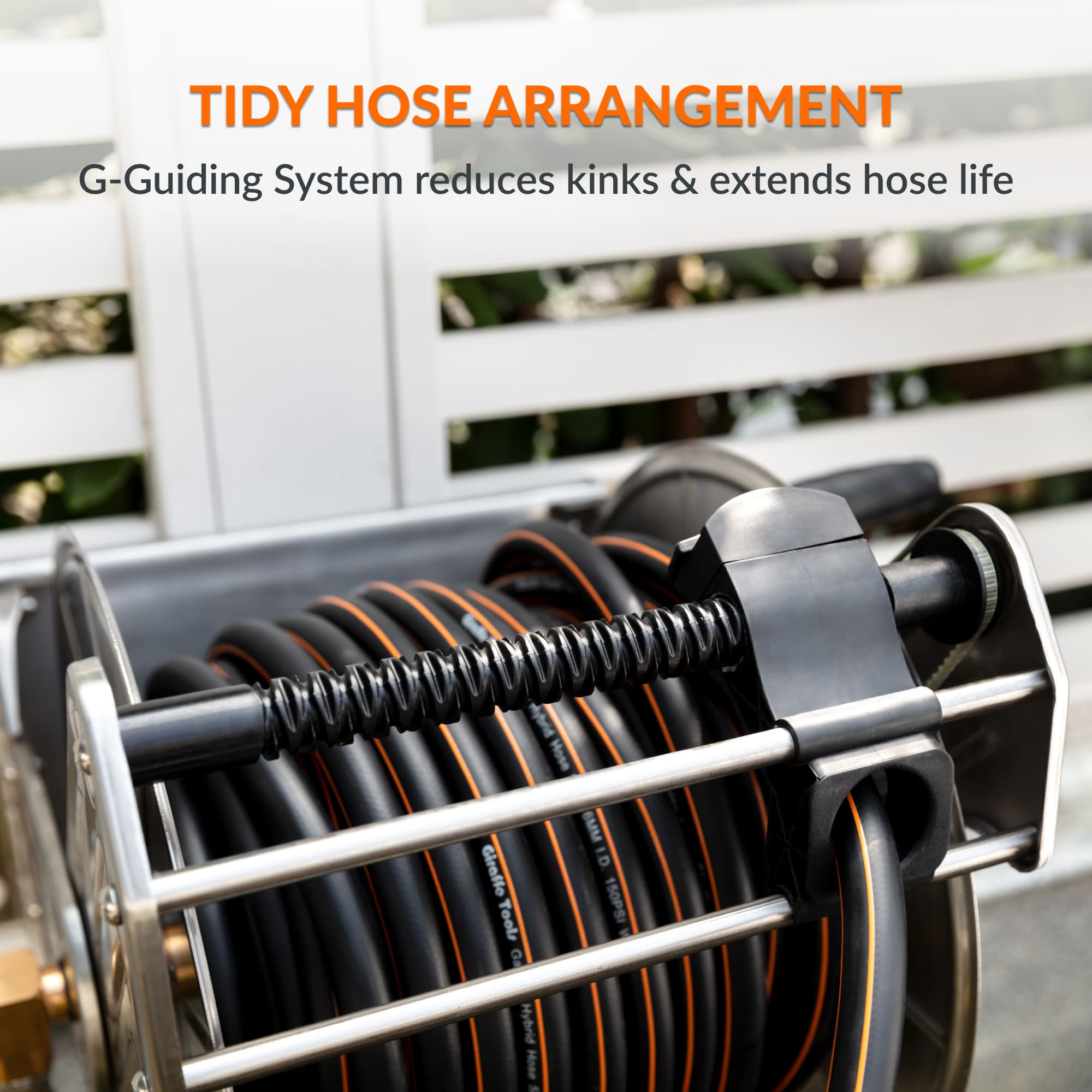 Wall hose reel with guide rail keeping coiled hose loops tidy