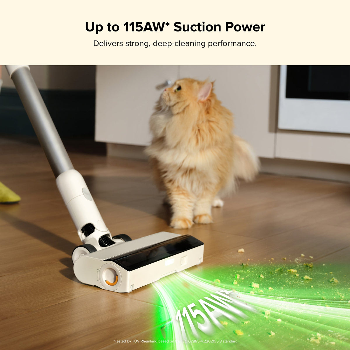 Cordless stick vacuum floor nozzle with green-lit suction cleaning a wood floor