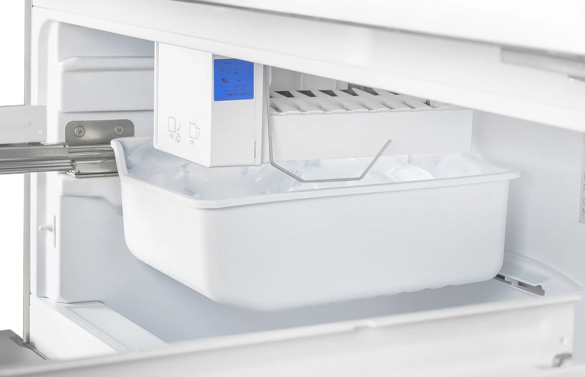 Stainless French door refrigerator ice bin drawer with white ice, interior close-up