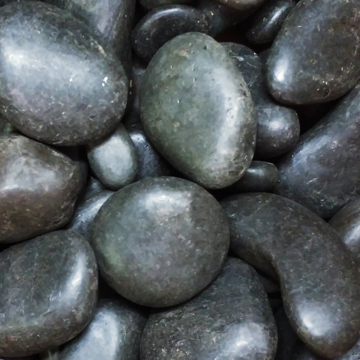 Round grey faux stones filling the firebox flame bed
