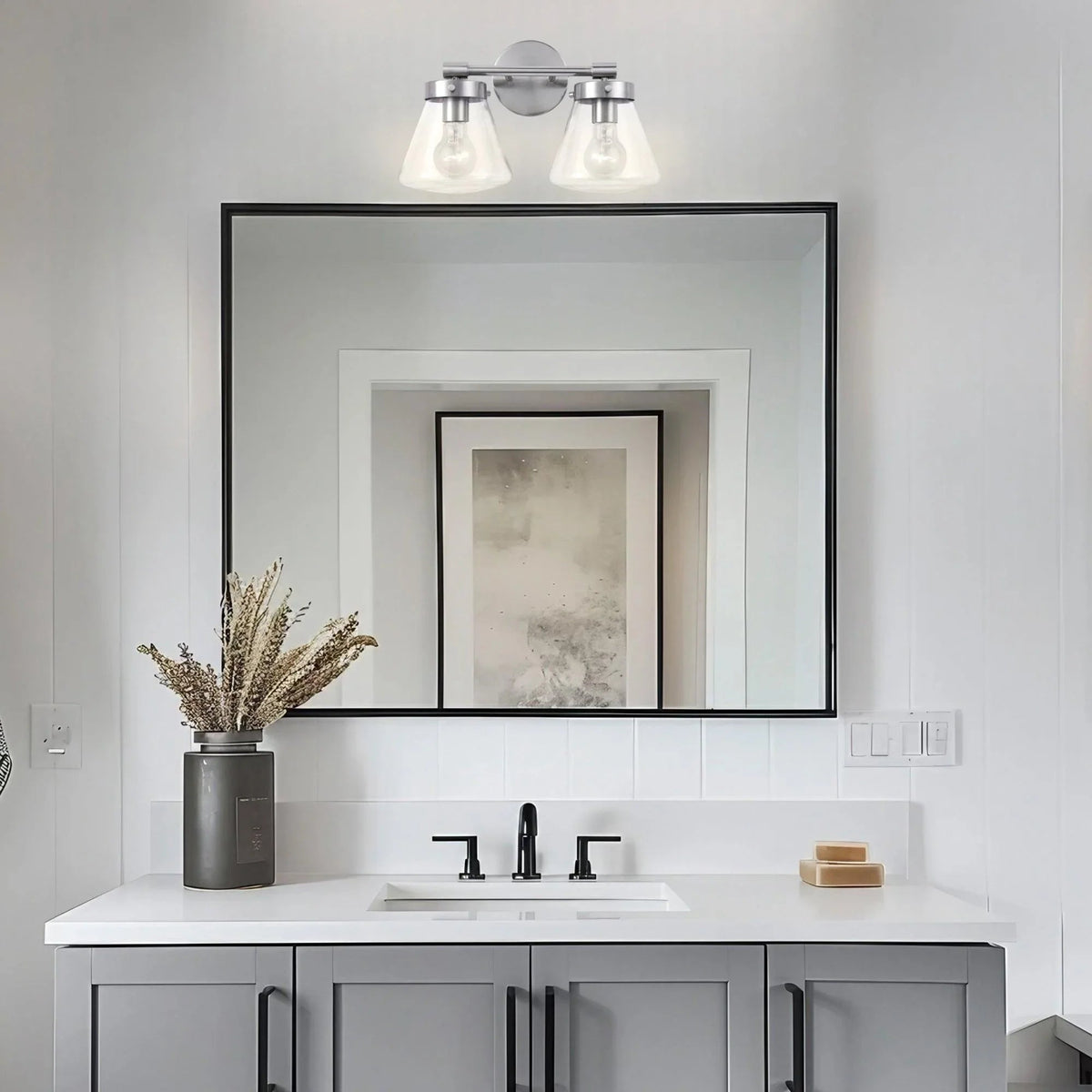 Black 2-light vanity light with clear glass shades and round wall backplate