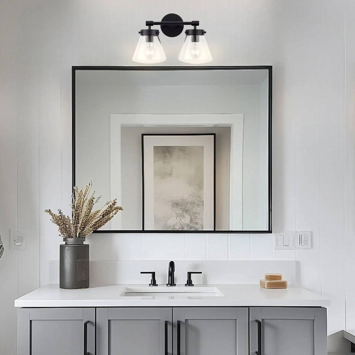 Black 2-light vanity light with two clear glass shades and horizontal bar