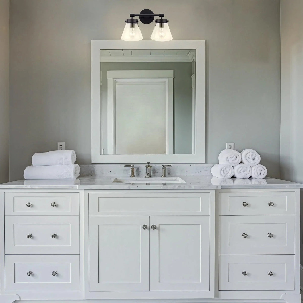 Black 2-light vanity light over bathroom vanity with clear glass shades