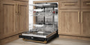 Stainless steel 24-inch built-in dishwasher with bronze trim, open door and dish racks